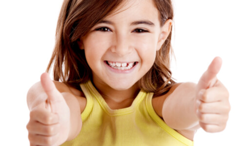 a girl happily smiling with a healthy teeth